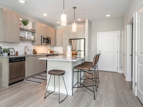 A modern kitchen with a bar stool and a countertop.