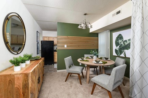 A dining room with a wooden table and chairs.