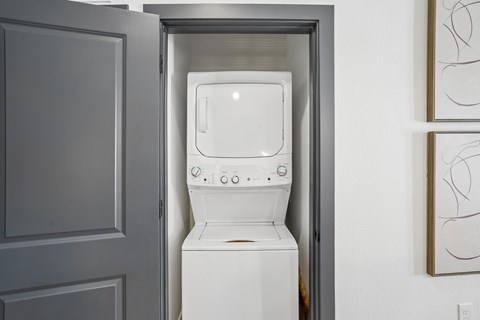 A white toilet is installed in a small space between a door and a wall.