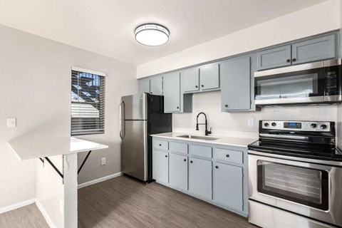 a kitchen with stainless steel appliances and white cabinets