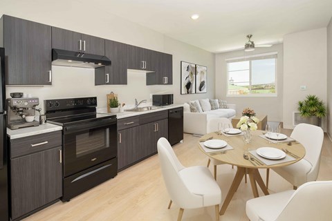 A modern kitchen with a dining table set for two.