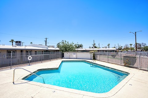 A small pool with a fence around it.