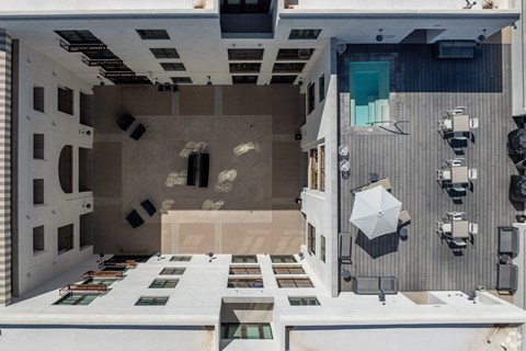 Aerial view of interior courtyard with pool and dining area at Monier Apartments, Tucson, AZ