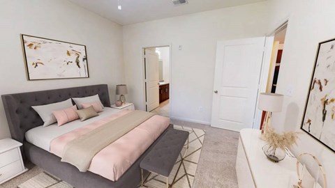 A bedroom with a large bed and a painting on the wall.