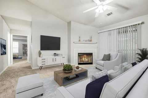 A living room with a fireplace, a television, and a couch.