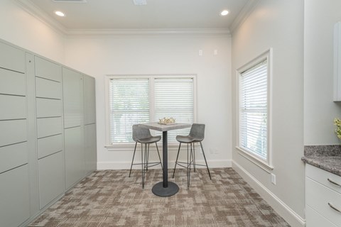 A dining area with a table and chairs.