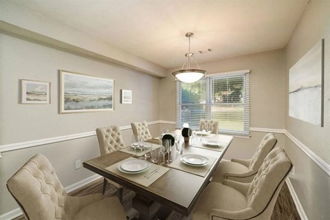 A dining room with a table set for four.