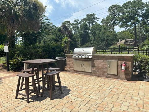 A patio with a table and chairs and a fire extinguisher on the wall.
