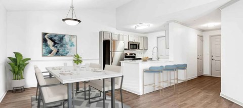 A modern kitchen with a dining table and chairs.