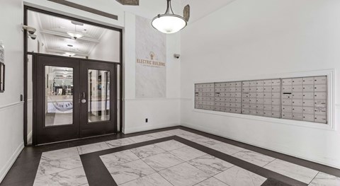 A hallway with a black and white checkered floor and a large calendar on the wall.