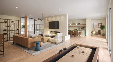 A modern living room with a shiny wooden floor and a pool table.