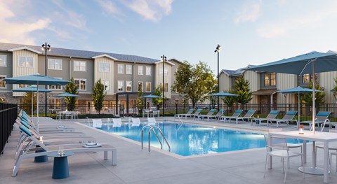 A pool area with lounge chairs and umbrellas in front of a building.