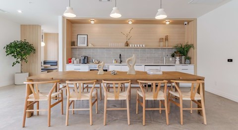 A modern dining room with a wooden table and chairs.