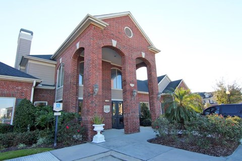 A red brick building with a white pillar in front.