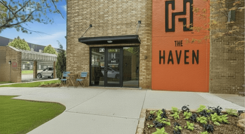 The Haven is a building with a brick facade and a large orange sign on the side.