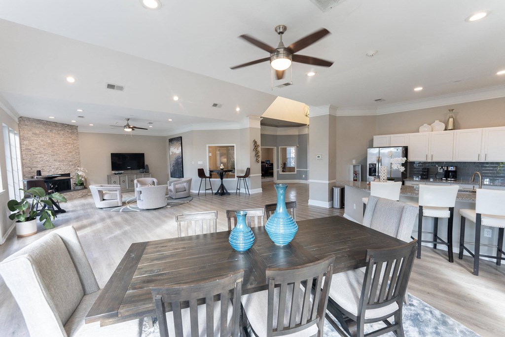 a large living room with a dining room table and chairs
