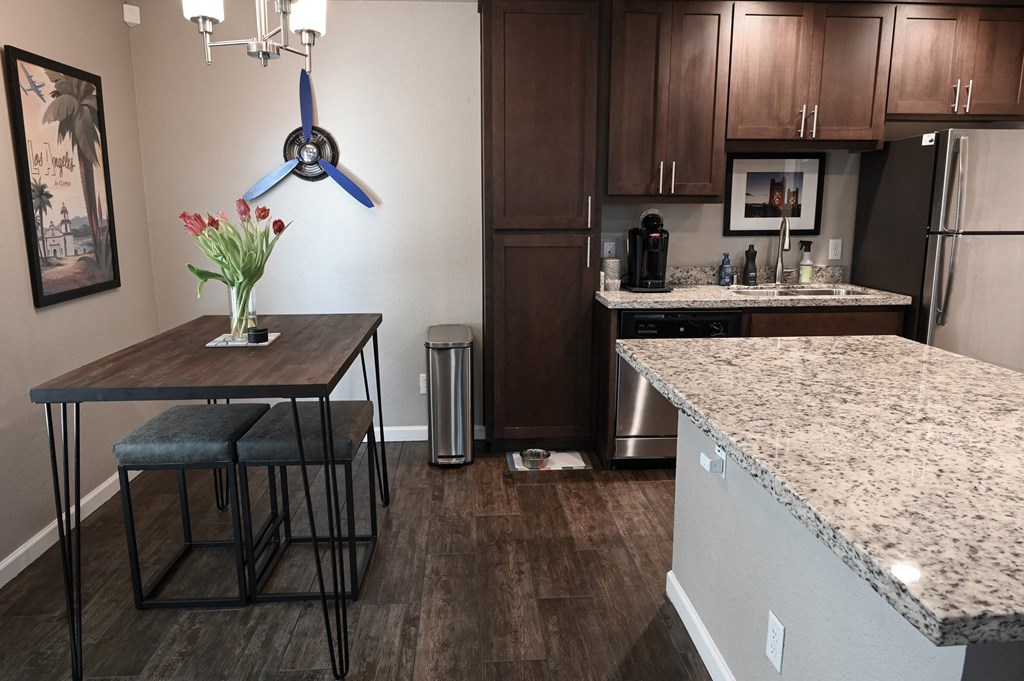 a kitchen with a table and two stools