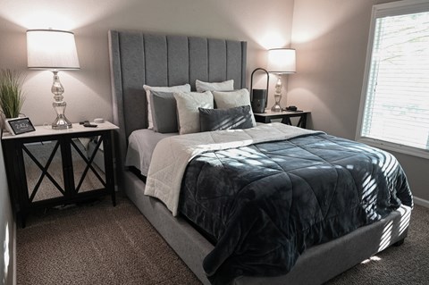 a bedroom with a bed and two nightstands
