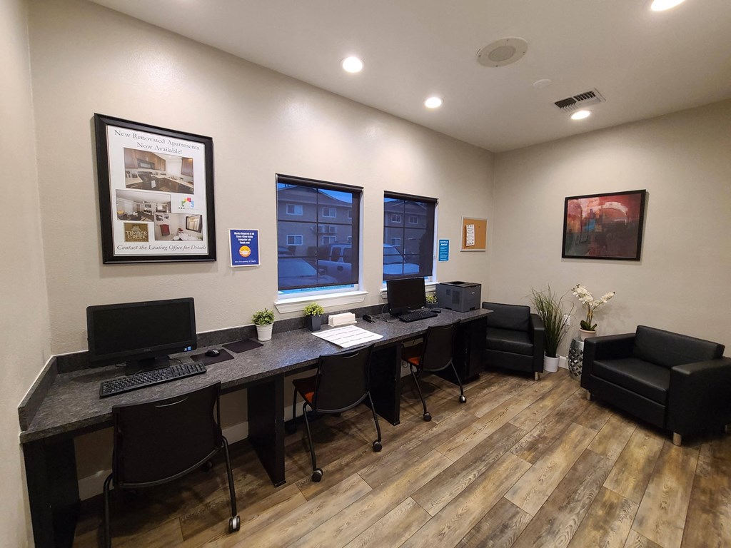 a computer room with two desks and two monitors and a chair