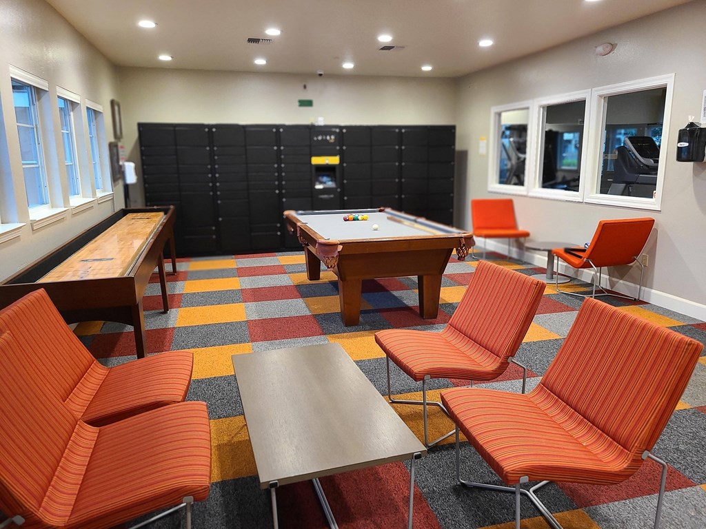 a game room with a pool table and tables