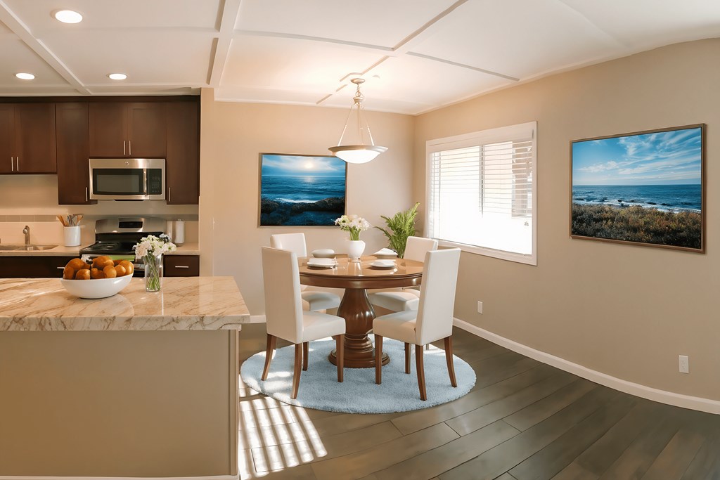A modern kitchen with a dining table and chairs.