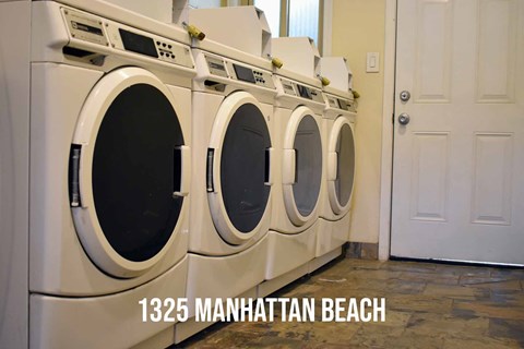 Community laundry area with multiple washers and dryers