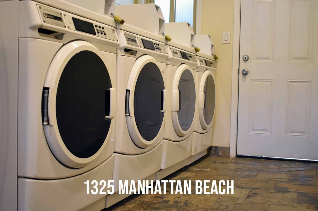 Community laundry area with multiple washers and dryers