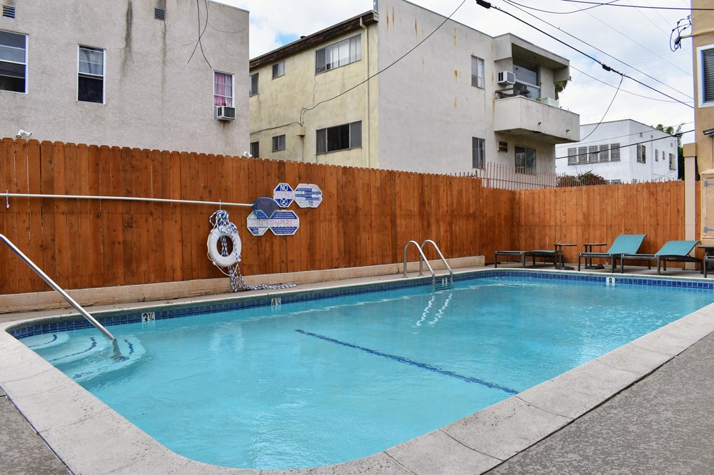 a swimming pool is shown in front of an apartment building