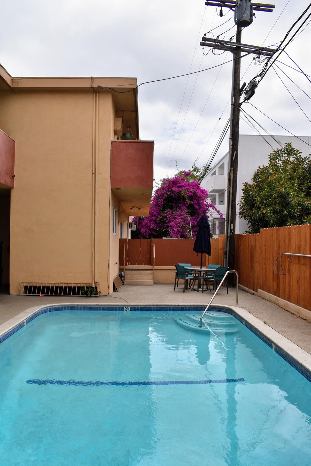 the pool is in the backyard of the house