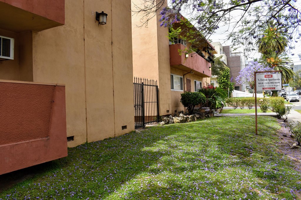 a yard in front of a building with a no parking sign