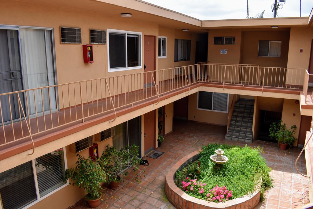 arium with a fountain in the middle of an apartment building