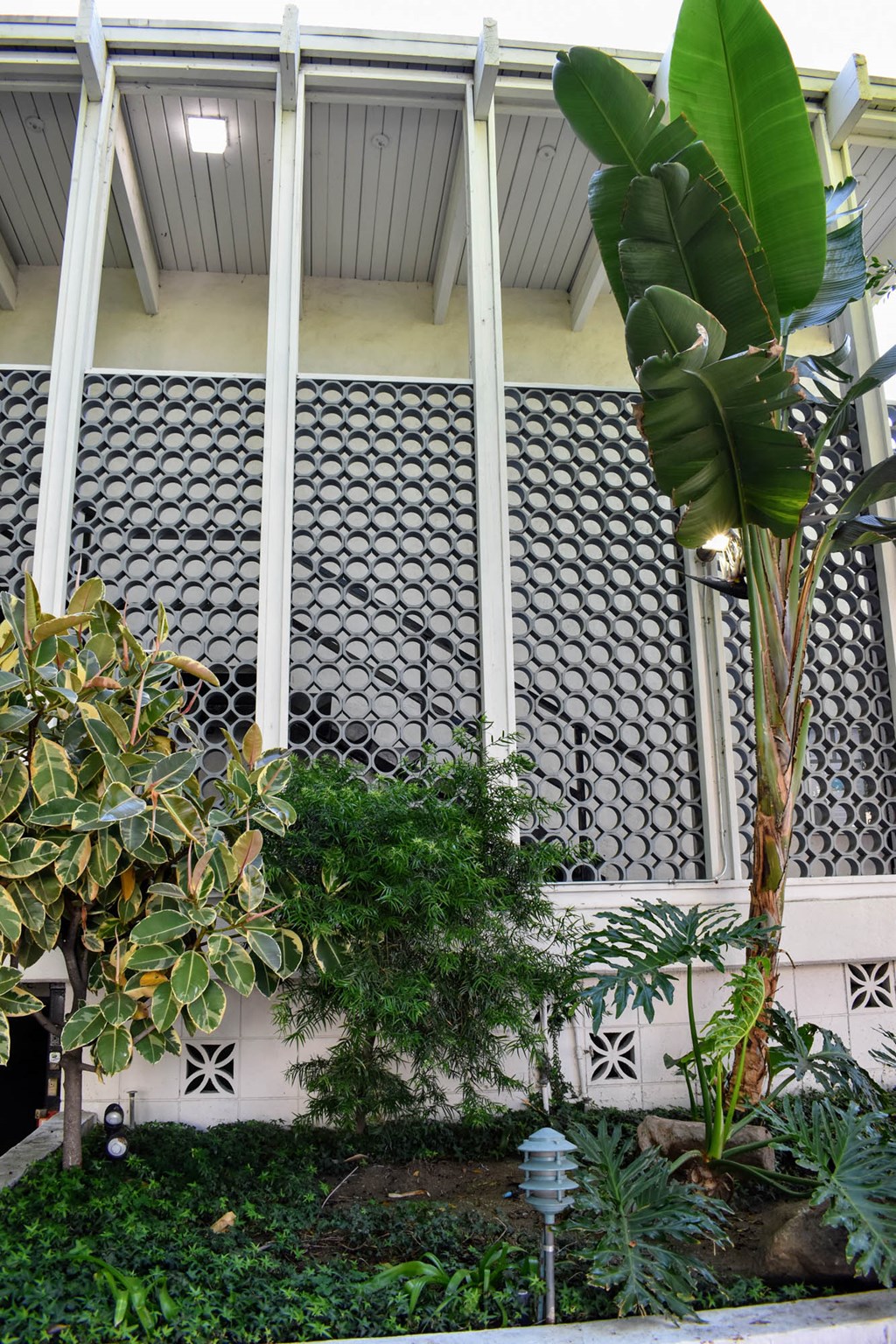 the facade of a house with a garden in front of it