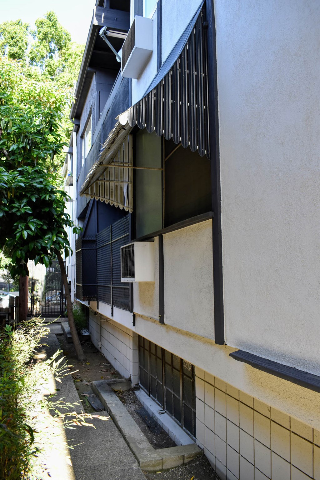 the side of a building with a window with bars on it