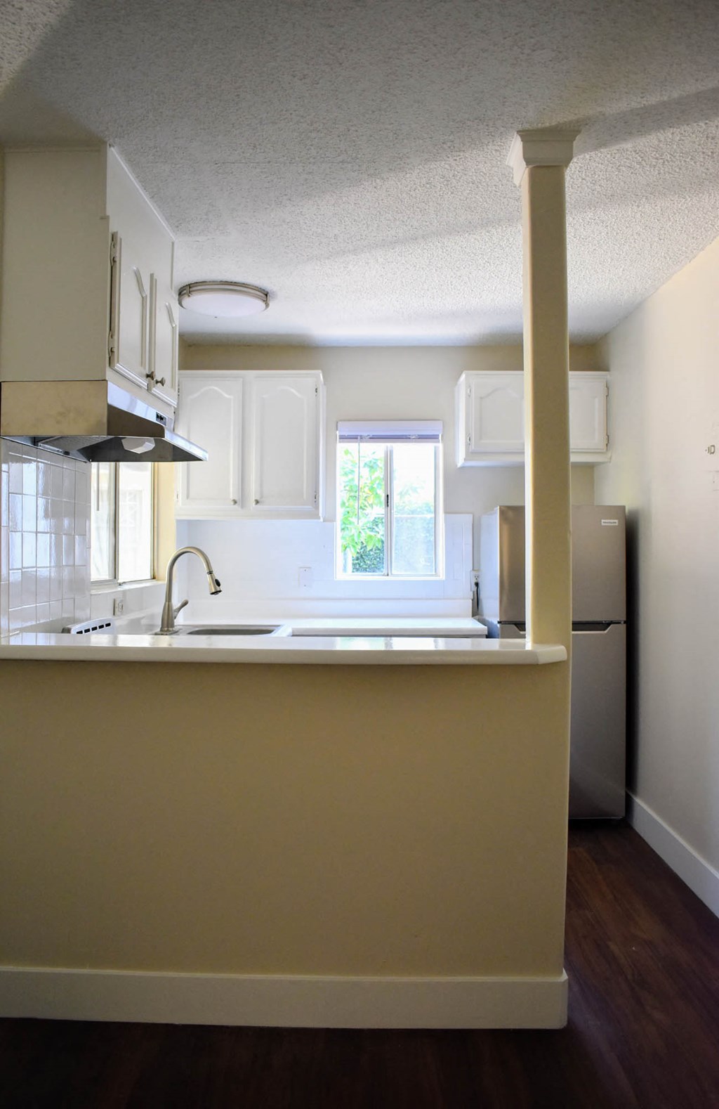 an empty kitchen with a sink and a window