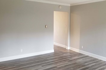 bedroom with wooden floors and neutral walls