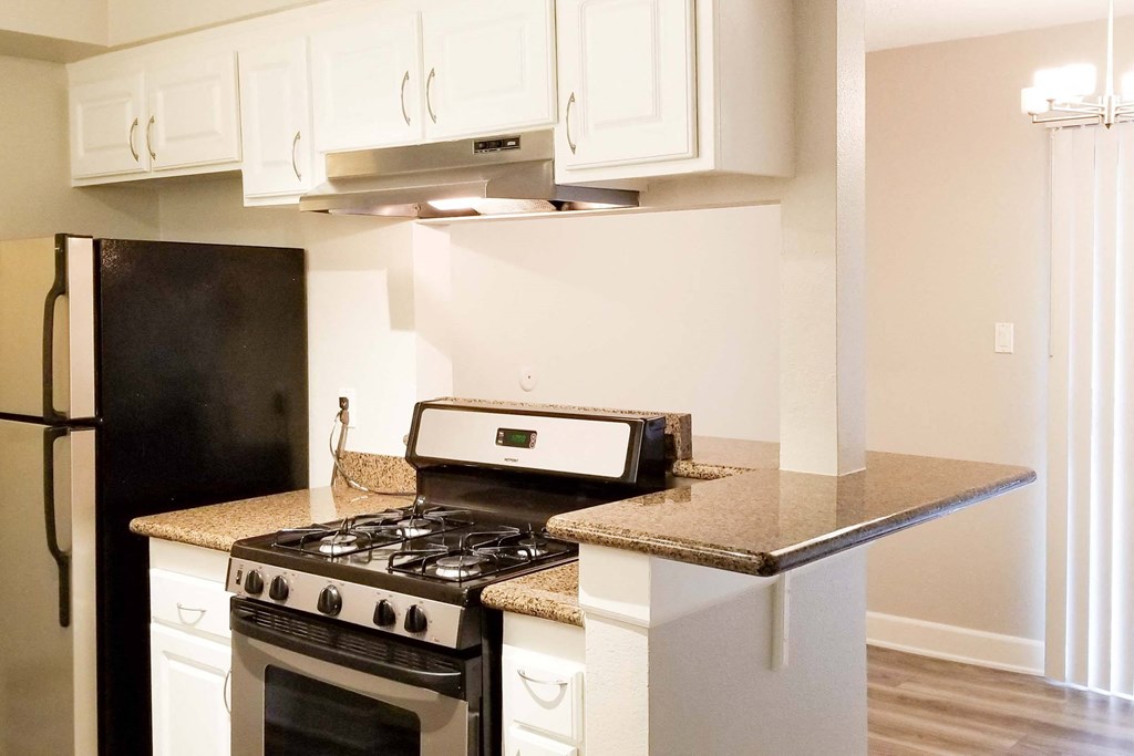 a kitchen with white cabinet