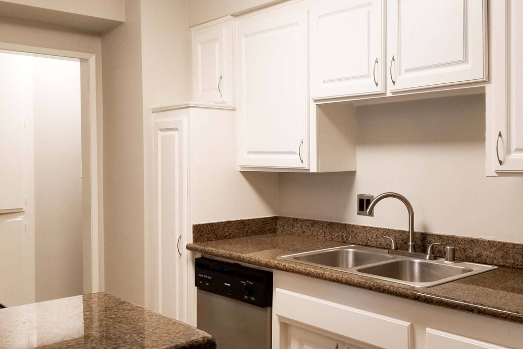 a kitchen with white cabinets