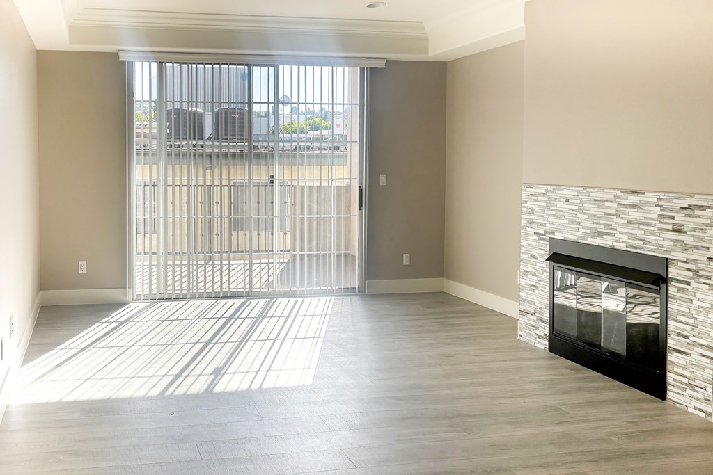 A room with a fireplace and a sliding glass door.