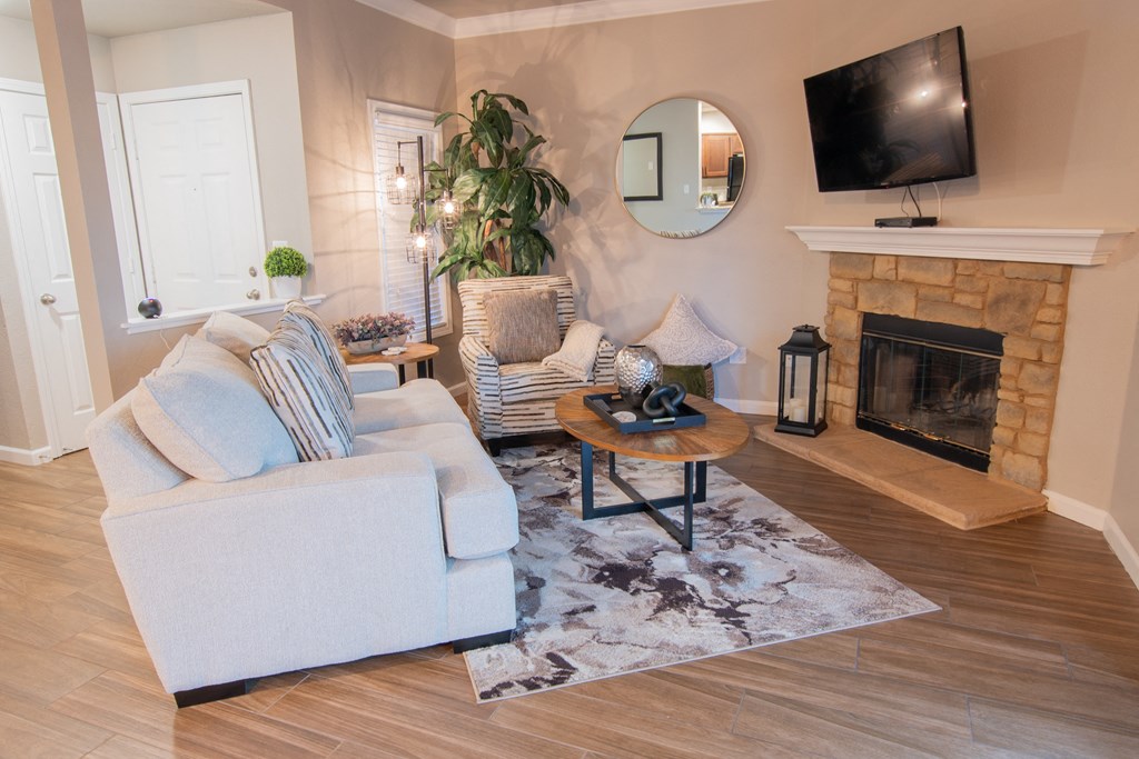 a living room with a fireplace and a tv