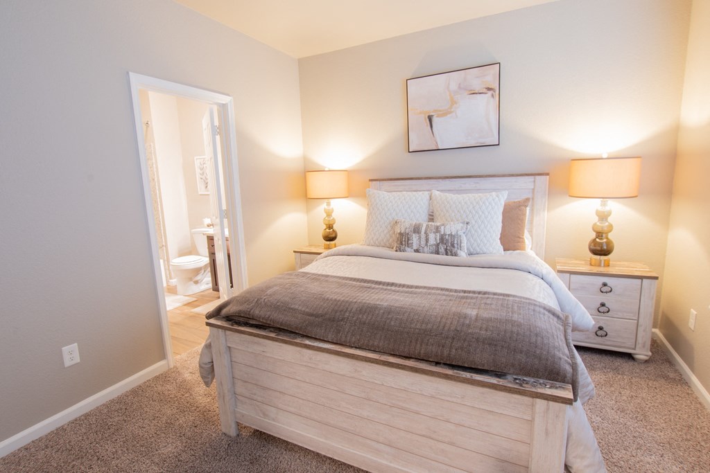 a bedroom with a bed and a bathroom with a toilet