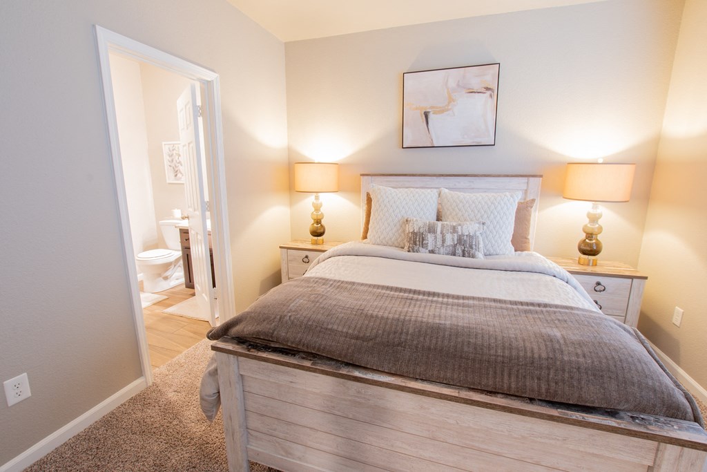 a bedroom with a bed and a bathroom with a toilet