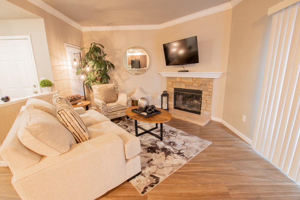 a living room with a couch and a fireplace and a tv