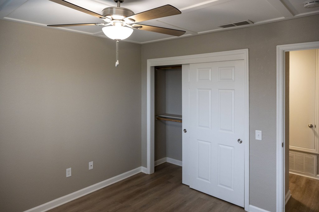 A room with a white door and a ceiling fan at Sierra Oaks Living Apartments, California