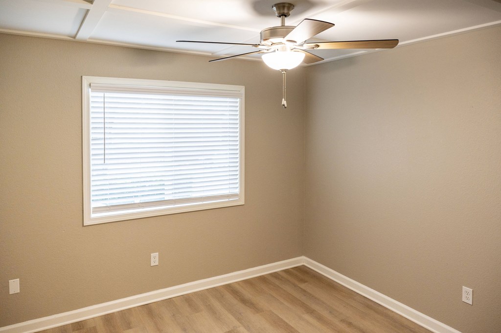 A room with a ceiling fan and a window with blinds at Sierra Oaks Living Apartments, Cameron Park