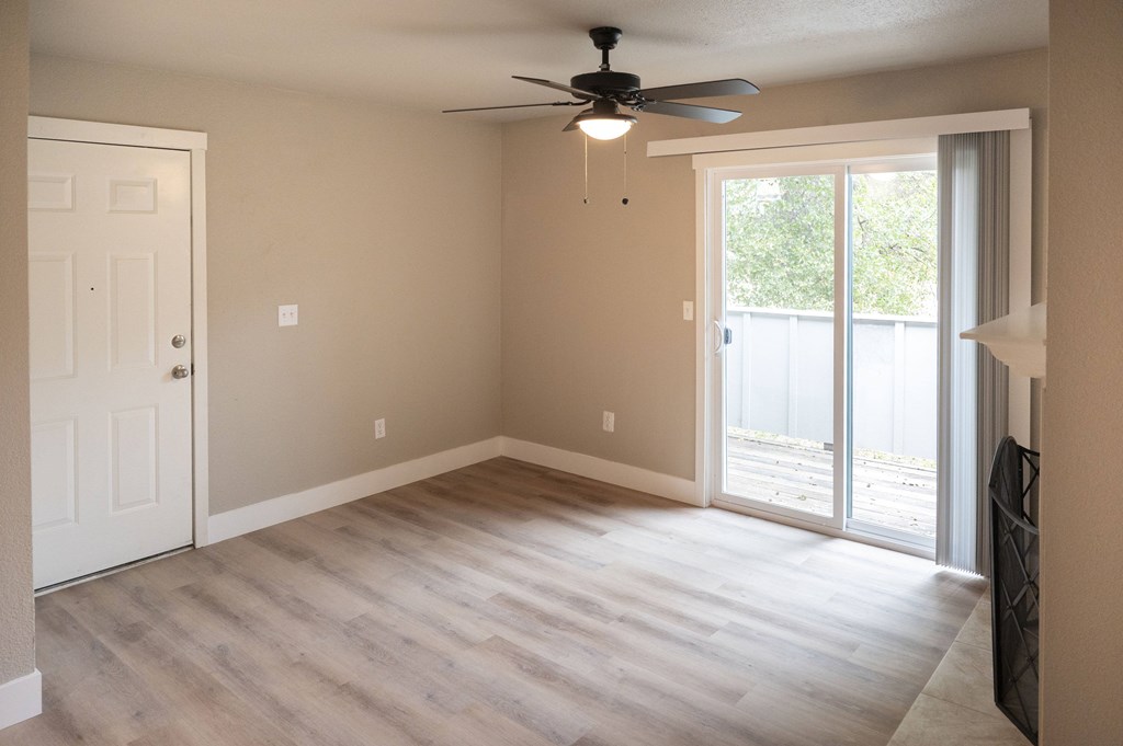 A room with a ceiling fan and sliding glass doors at Sierra Oaks Living Apartments, Cameron Park 95682
