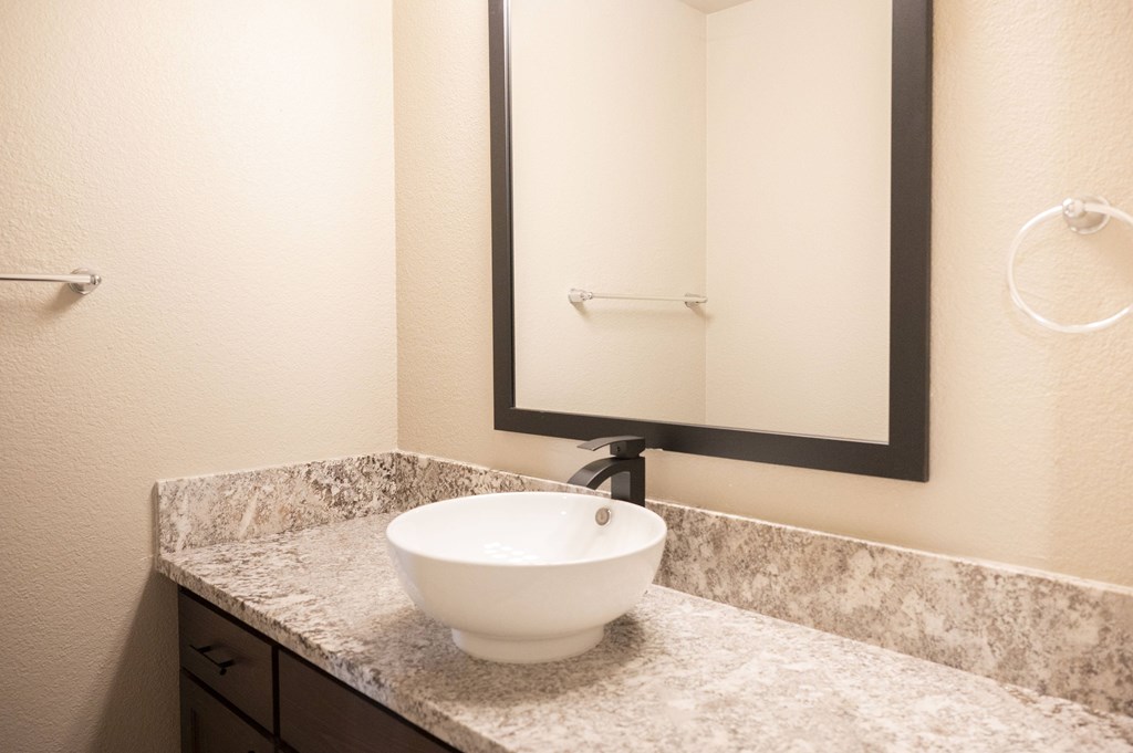 A white bowl sink is on a marble countertop at Sierra Oaks Living Apartments, Cameron Park, California