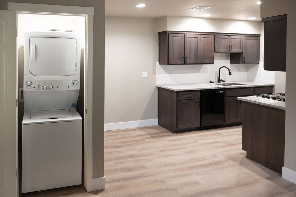 A modern kitchen with a white oven and wooden cabinets at Sierra Oaks Living Apartments, Cameron Park 95682