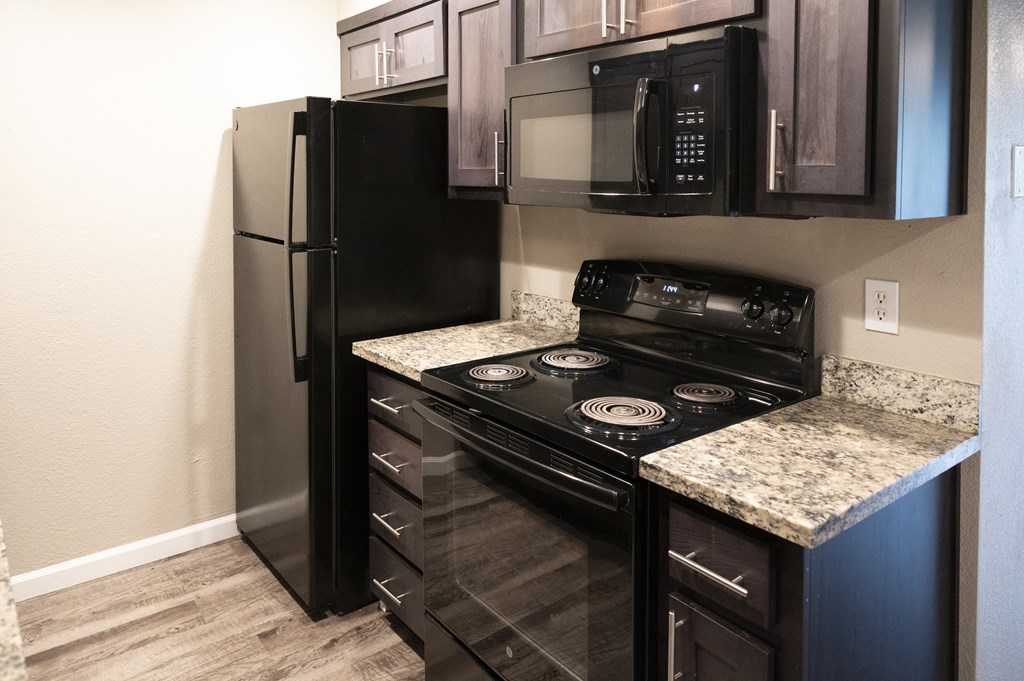 A black stove and refrigerator in a kitchen at Sierra Oaks Living Apartments, Cameron Park 95682