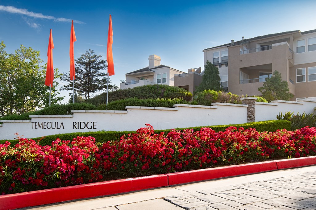 A sign that says  Temecula Ridge in front of a building.