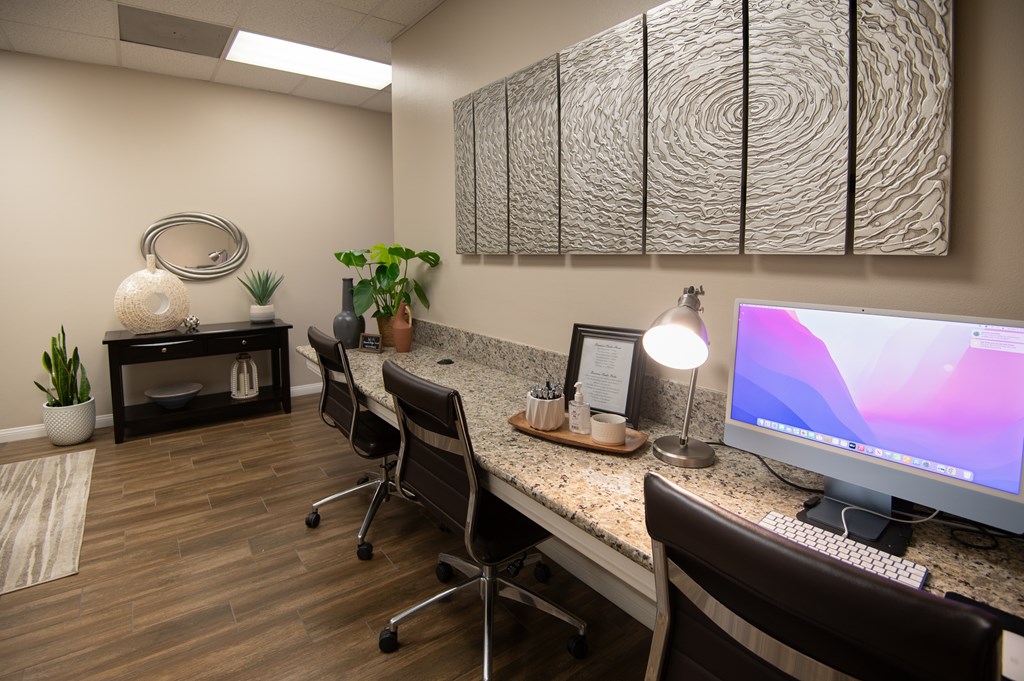 A modern office with a wooden desk and a computer monitor.